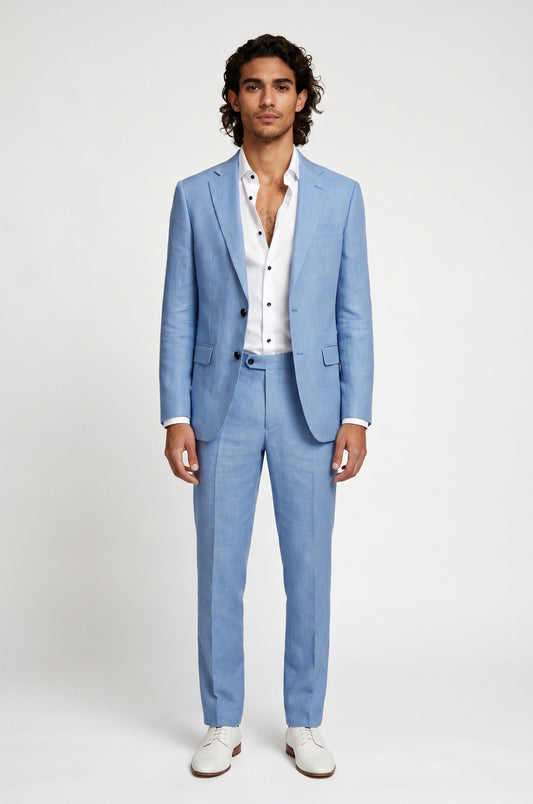Man wearing a light blue linen suit with a white shirt on a plain background