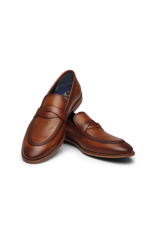 Pair of brown leather loafers on a white background