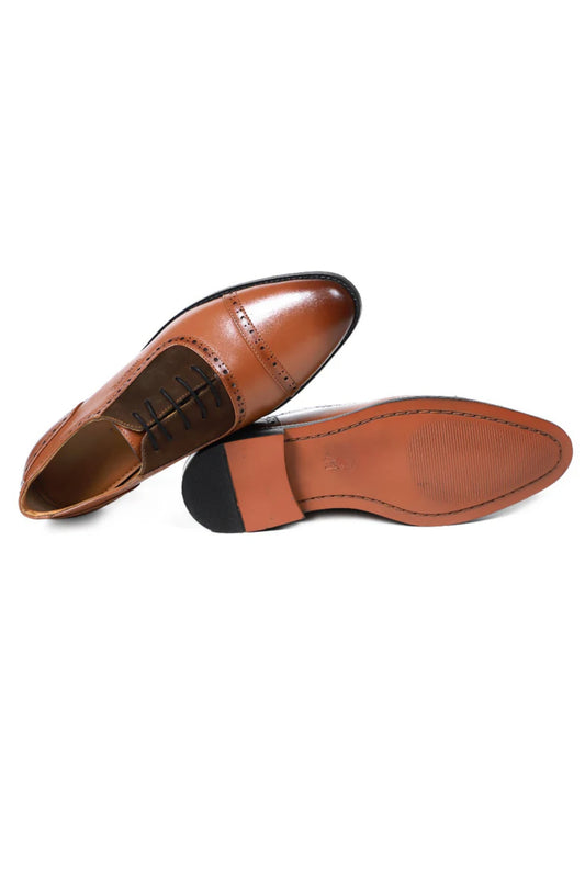 Pair of brown leather shoes on a white background