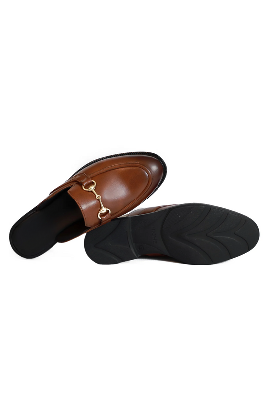 Brown leather loafer with gold buckle on a white background