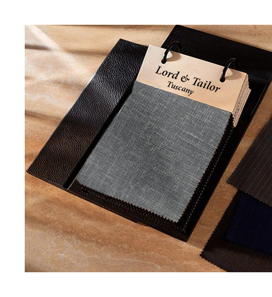 Fabric swatches with 'Lord & Tailor Tuscany' label on a wooden surface