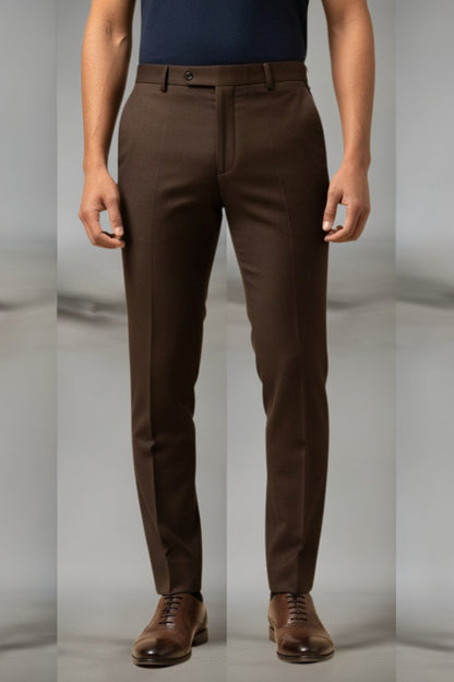 Brown pants worn by a person on a plain background