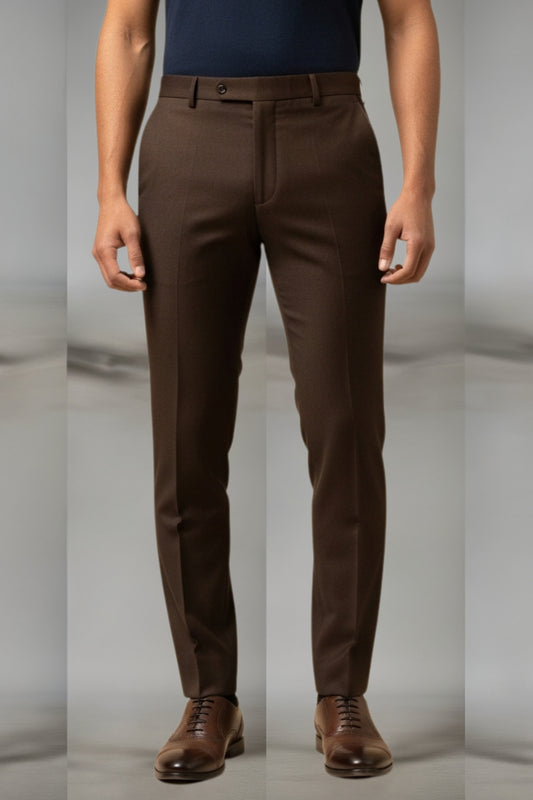 Brown pants worn by a person on a plain background