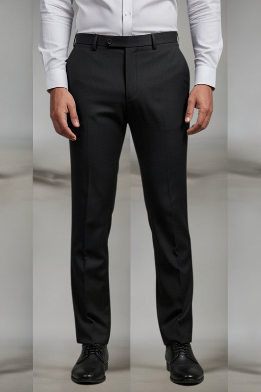 Black dress pants worn with a white shirt and black shoes on a neutral background