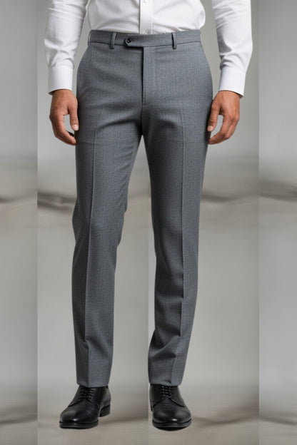 Gray dress pants worn with a white shirt and black shoes on a neutral background