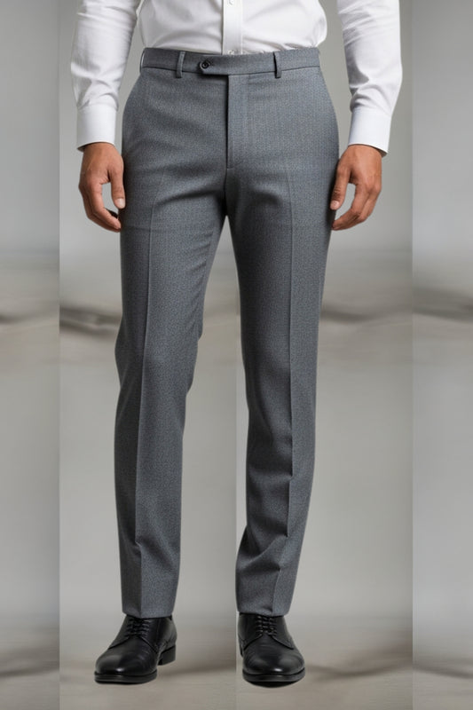 Gray dress pants worn with a white shirt and black shoes on a neutral background