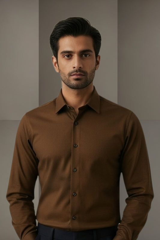 Man wearing a brown shirt against a neutral background