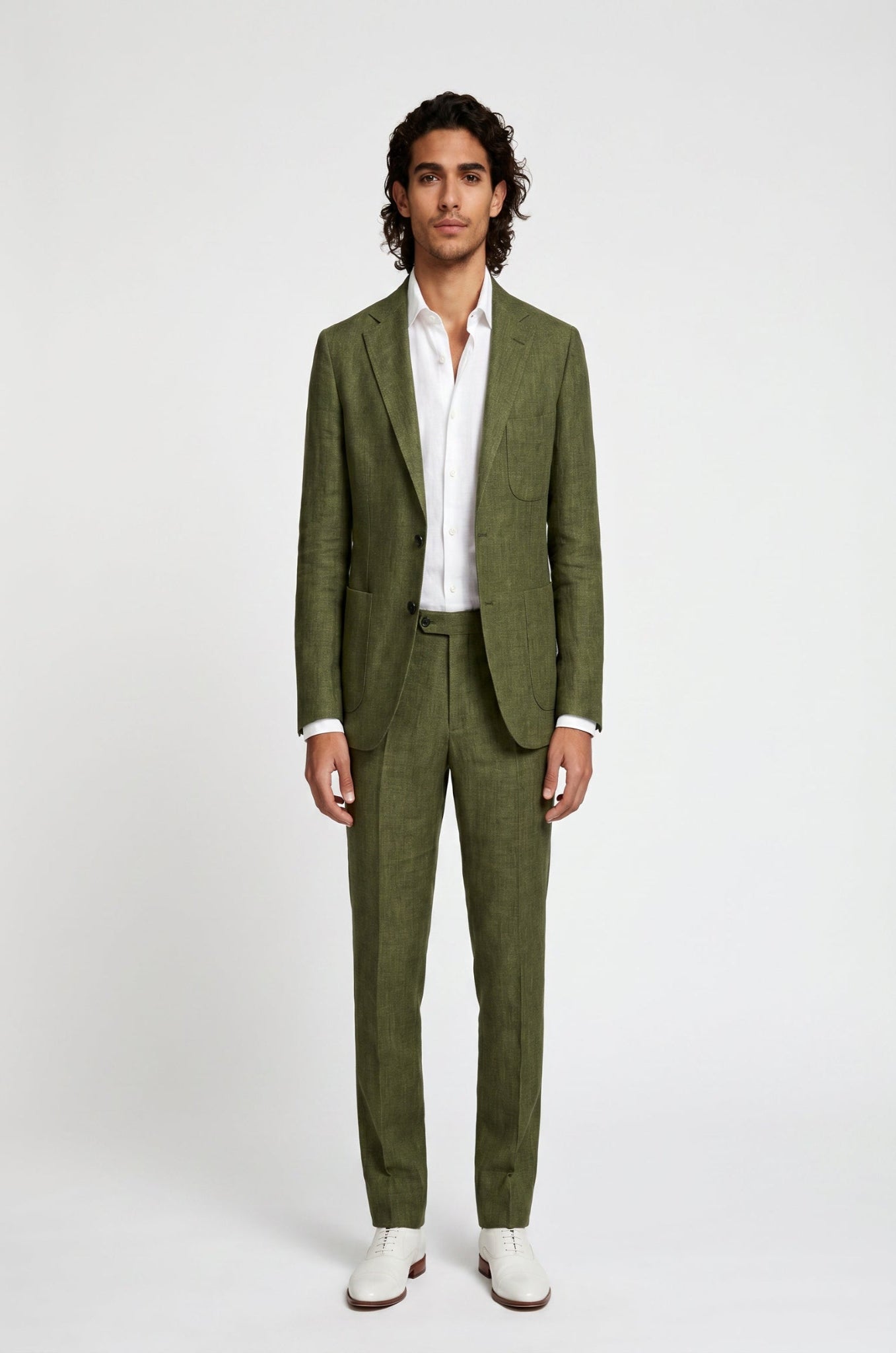 Man wearing a green suit with a white shirt on a white background