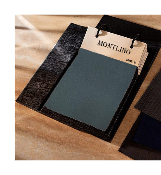 Dark green leather sample with a 'Montlino' tag on a wooden surface