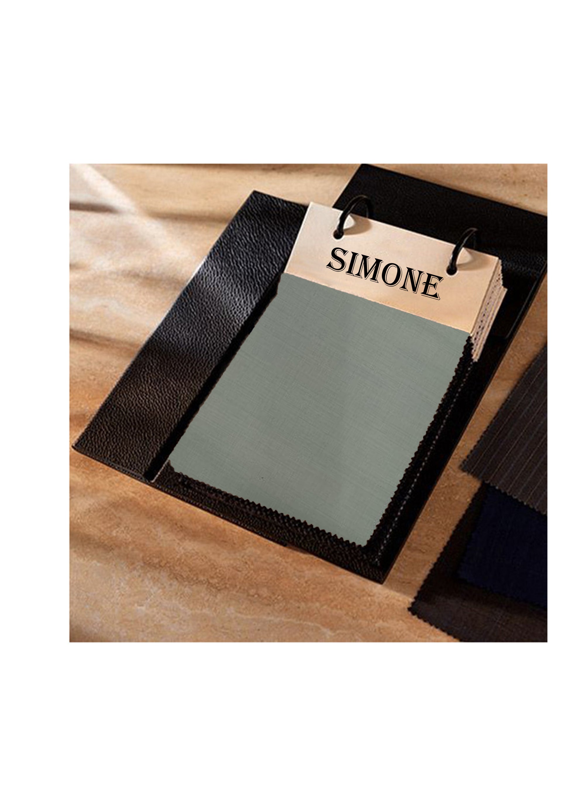Fabric swatch with 'SIMONE' label on a wooden surface