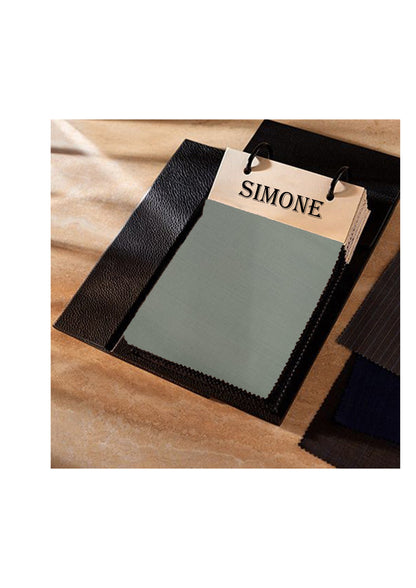 Fabric swatch with 'SIMONE' label on a wooden surface