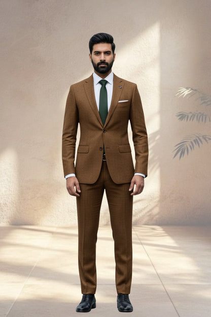 Man wearing a brown suit with a green tie against a neutral background