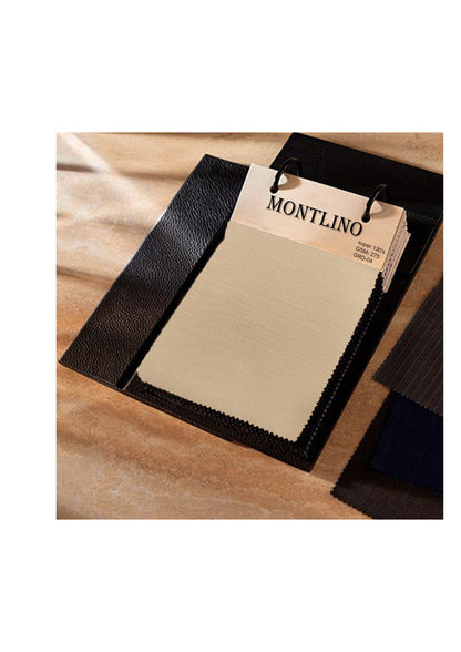 Black leather sample with a 'Montlino' tag on a wooden surface